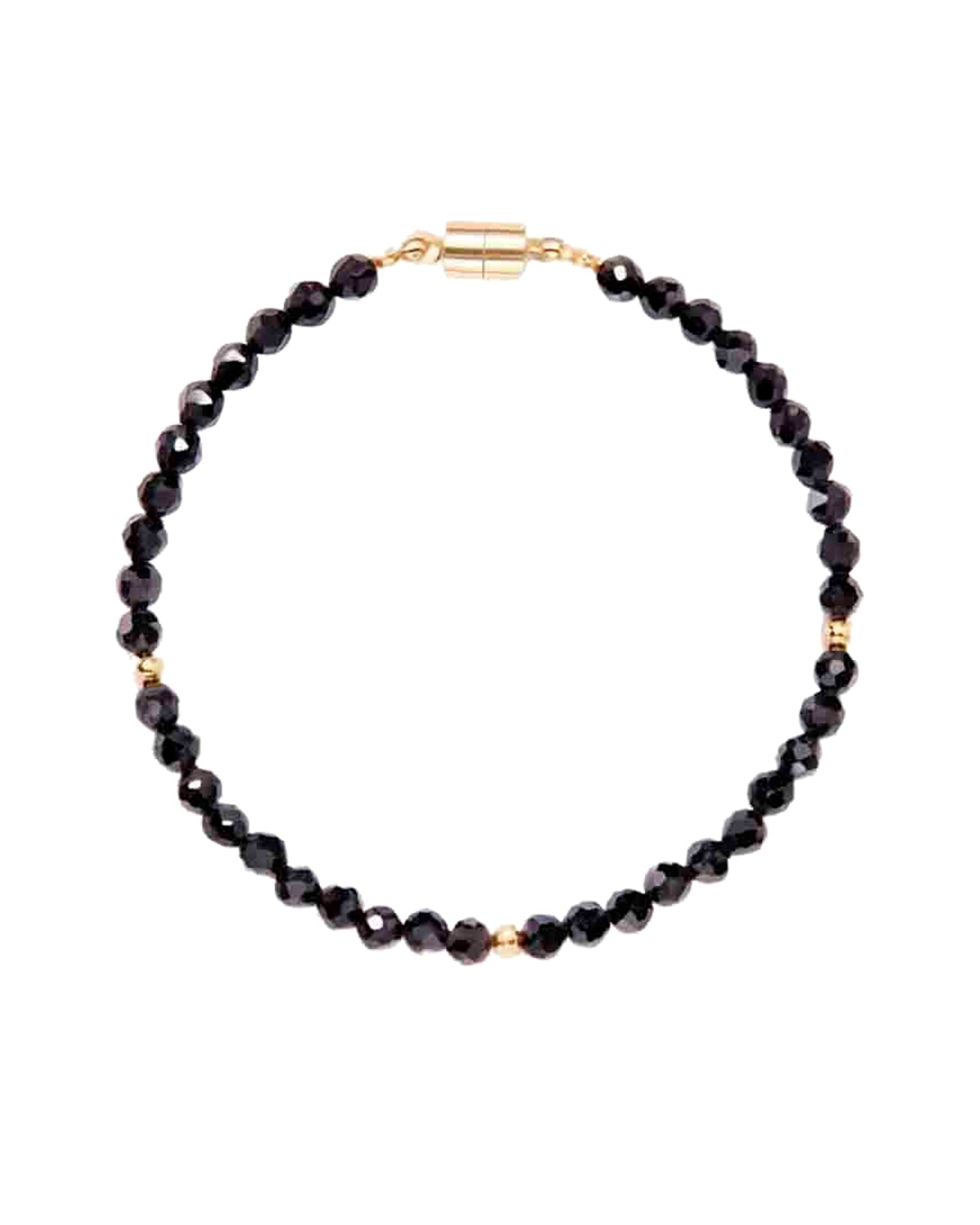 Black beaded necklace with a gold clasp on a white background