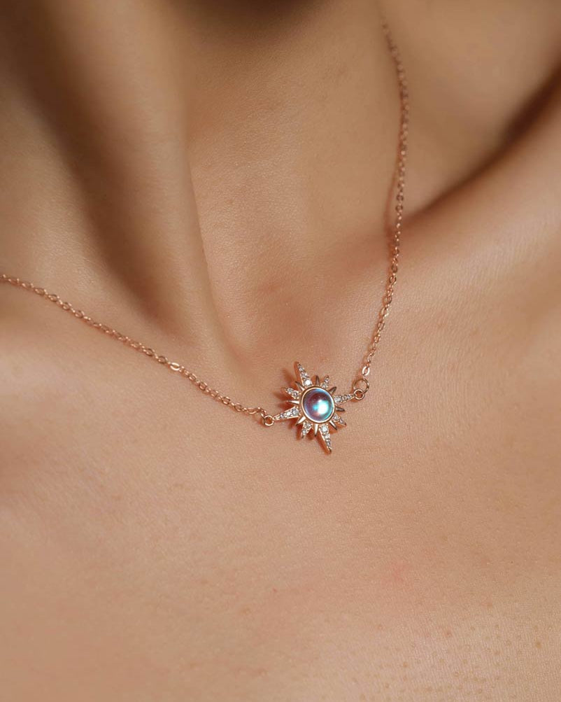 Model wearing Choodo rose gold sun moonstone pendant necklace around the neck