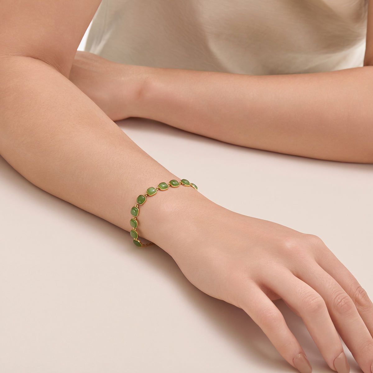 Close-up photography of Choodo minimalist natural green Jade square interlock silver bracelet styled on a model's wrist, highlighting modern geometric wardrobe elegance.