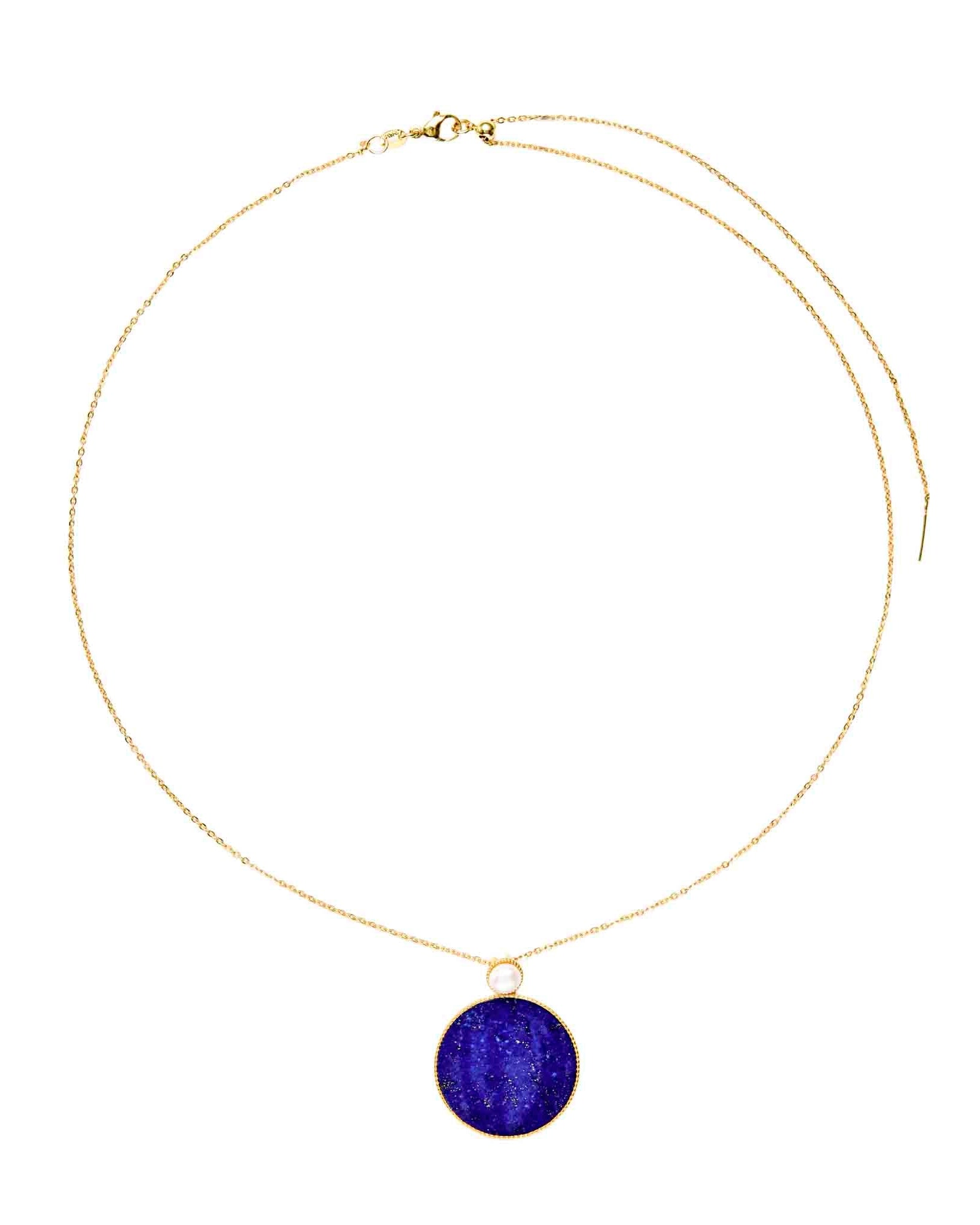 Gold necklace with a purple pendant on a white background