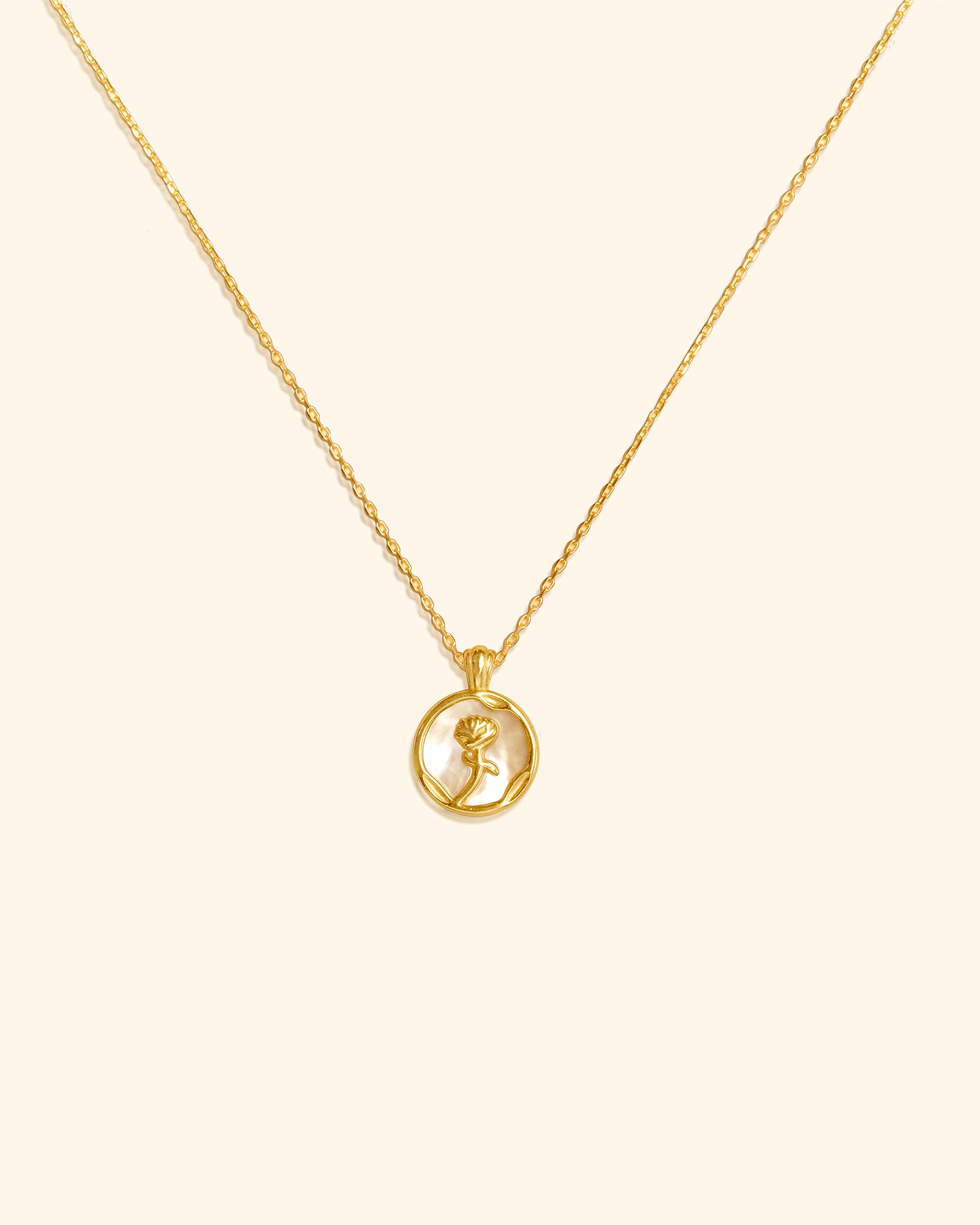 Choodo 18k gold plated sterling silver rose necklace with mother of pearl disc pendant on cream background