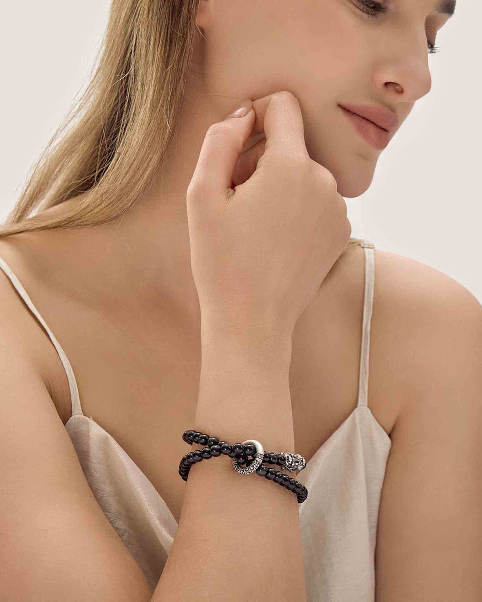 Choodo men's minimalist natural Obsidian crystal bracelet with silver Pixiu amulet worn on a male model's wrist, premium masculine fashion jewelry style.