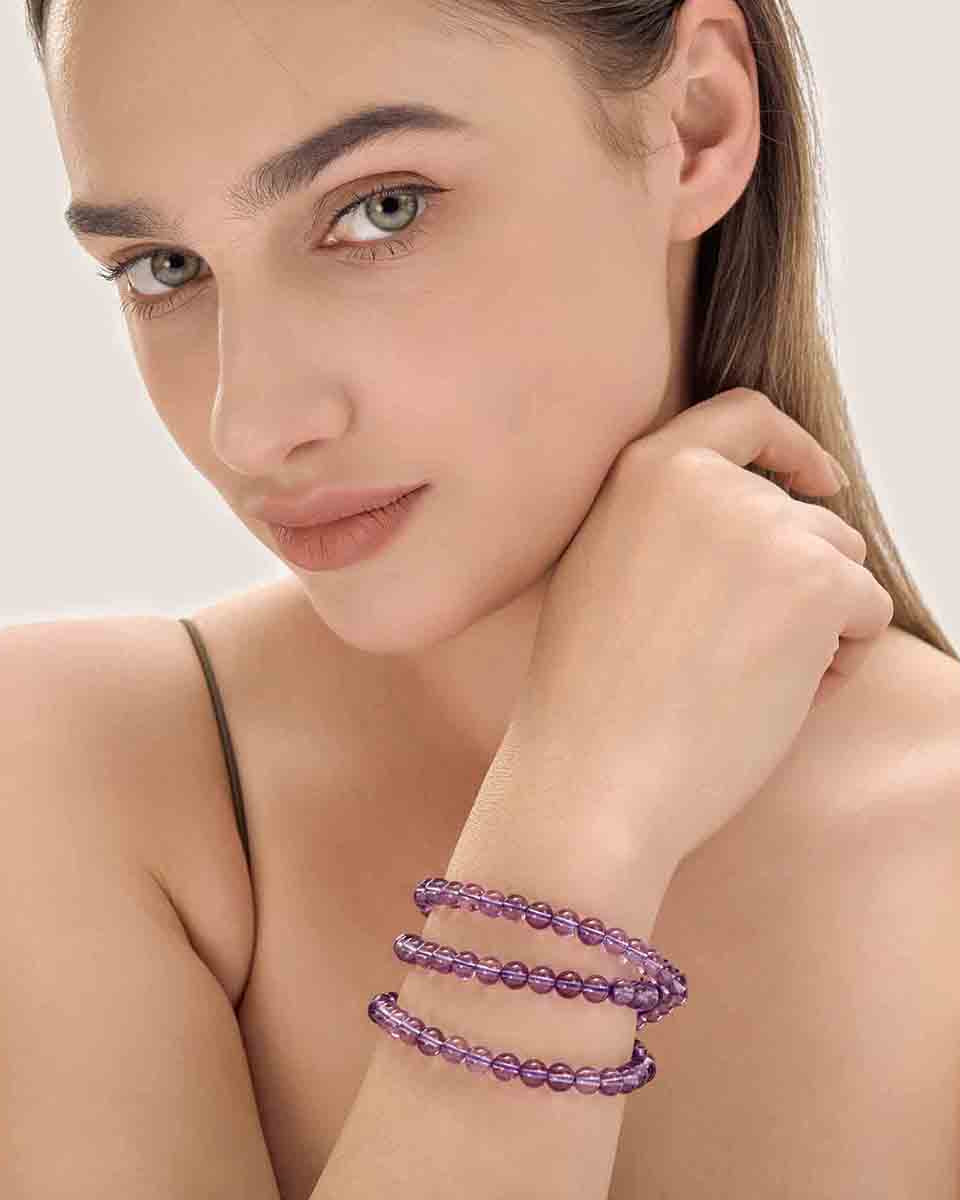 Choodo minimalist natural Amethyst Quartz three-layer crystal bracelet worn on a model's wrist.