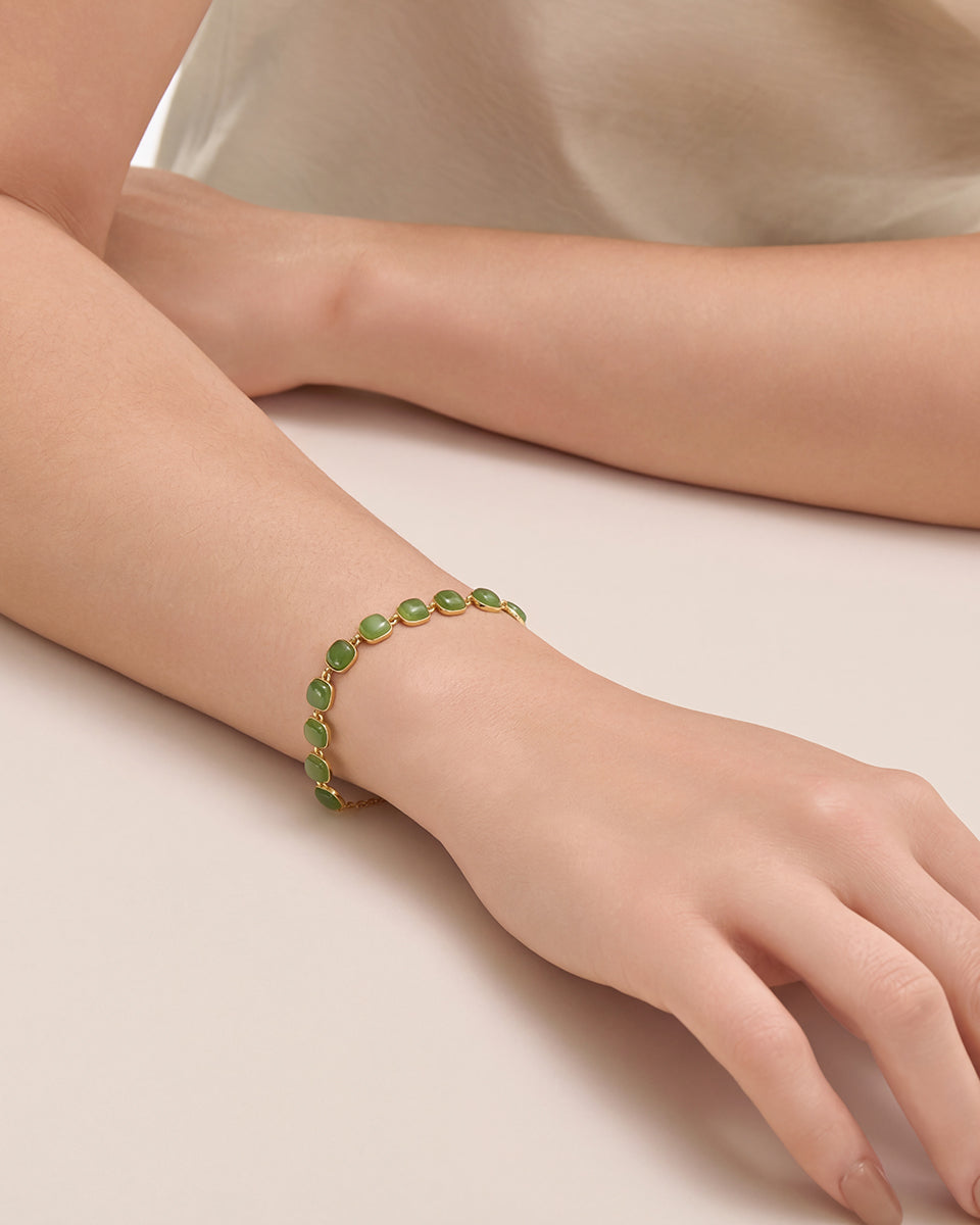 Close-up photography of Choodo minimalist natural green Jade square interlock silver bracelet styled on a model's wrist, highlighting modern geometric wardrobe elegance.