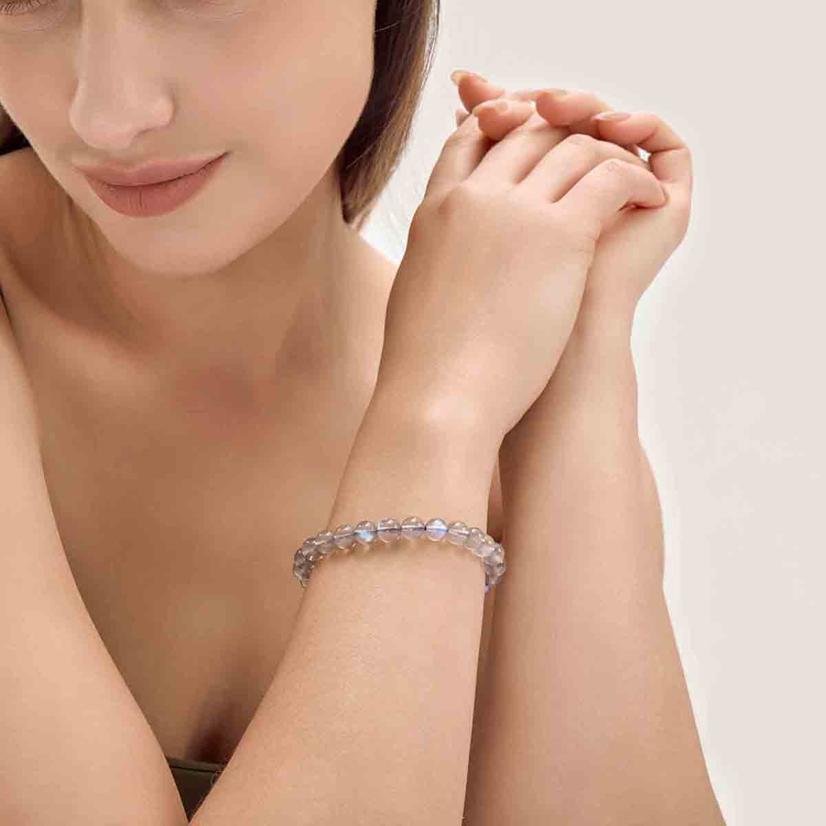 Choodo minimalist natural Veil Grey Moonstone crystal bracelet styled on a model's wrist, romantic vintage fashion aesthetic.