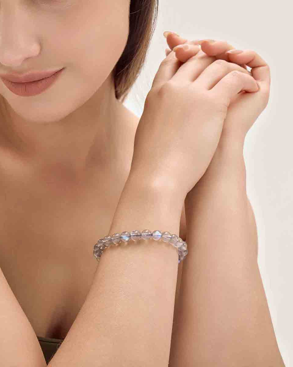 Choodo minimalist natural Veil Grey Moonstone crystal bracelet styled on a model's wrist, romantic vintage fashion aesthetic.